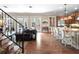 This open-concept living room and kitchen features hardwood floors, recessed lighting and an island with seating at 4350 New Broad St, Orlando, FL 32814