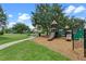 Community playground with slides, climbing structures, and soft landing, set in a grassy area at 4350 New Broad St, Orlando, FL 32814
