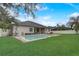 Spacious backyard featuring a well-maintained pool, grassy area, and covered patio perfect for outdoor entertaining at 440 Skyview Pl, Chuluota, FL 32766