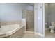 Bright bathroom with a soaking tub adjacent to a tiled shower and a separate toilet area at 440 Skyview Pl, Chuluota, FL 32766