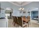 Stylish dining room with modern chandelier and view to Gathering room at 440 Skyview Pl, Chuluota, FL 32766