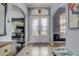 Elegant foyer with double doors, tiled flooring, arched doorways, and stylish decor at 440 Skyview Pl, Chuluota, FL 32766
