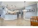 Bright kitchen features white cabinetry, pendant lighting, stainless steel appliances and granite counters at 440 Skyview Pl, Chuluota, FL 32766