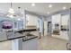Open kitchen features stainless steel appliances, granite counters, white cabinets, and recessed lighting at 440 Skyview Pl, Chuluota, FL 32766