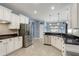 Updated kitchen featuring stainless steel appliances, granite counters, white cabinets, and tile backsplash at 440 Skyview Pl, Chuluota, FL 32766