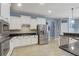 Bright kitchen features granite counters, stainless appliances, white cabinets and tile floors at 440 Skyview Pl, Chuluota, FL 32766