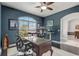 Comfortable home office with large window, dark walls, and hardwood flooring at 440 Skyview Pl, Chuluota, FL 32766