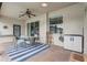 Covered patio featuring brick pavers, furniture, a ceiling fan, and backyard views at 440 Skyview Pl, Chuluota, FL 32766