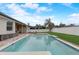 The pool and patio features a white fence, green grass, and outdoor furniture for relaxing and entertaining at 440 Skyview Pl, Chuluota, FL 32766