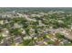 High-altitude aerial view of a neighborhood near commercial thoroughfare; home has pool, curved drive and lots of trees at 4436 Larado Pl, Orlando, FL 32812