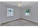 Neutral carpeted bedroom with large windows and a ceiling fan at 4436 Larado Pl, Orlando, FL 32812