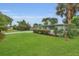 Lush green lawn and landscaping complement this inviting single-story home at 4436 Larado Pl, Orlando, FL 32812