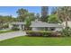 Landscaped front yard and driveway leading up to the charming single-story home at 4436 Larado Pl, Orlando, FL 32812