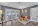Living room with neutral gray walls and a view of the outdoor patio and pool at 4436 Larado Pl, Orlando, FL 32812