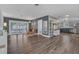 Open-concept living space with wood floors, kitchen, and sliding door to the patio at 4436 Larado Pl, Orlando, FL 32812