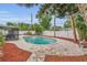 Backyard pool with concrete decking, lush landscaping, privacy fence, and screened in porch; perfect for outdoor living at 4436 Larado Pl, Orlando, FL 32812