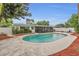 Inviting backyard pool with concrete deck and screen porch is surrounded by lush landscaping and a white privacy fence at 4436 Larado Pl, Orlando, FL 32812