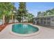 Backyard swimming pool with an outdoor patio area and mature trees at 4436 Larado Pl, Orlando, FL 32812