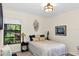 Bedroom with natural light, closet, and tasteful decor and a view to the lush landscaping at 445 Songbird Way, Apopka, FL 32712
