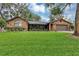 Well-maintained brick house featuring manicured landscaping, flowers, and a manicured lawn at 445 Songbird Way, Apopka, FL 32712
