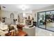 Cozy living room featuring stylish furnishings, a view to the kitchen, and access to the outdoor seating area at 445 Songbird Way, Apopka, FL 32712