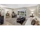 Inviting living room featuring a bay window with bench seating and neutral color palette at 445 Songbird Way, Apopka, FL 32712