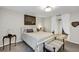 Comfortable bedroom with white furniture, bench, and large picture window allowing natural light at 445 Songbird Way, Apopka, FL 32712