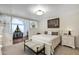Bright main bedroom with white furniture, neutral tones, and a decorative window feature at 445 Songbird Way, Apopka, FL 32712