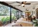 Spacious screened patio provides seating areas, fan, and views of lush landscaping and backyard at 445 Songbird Way, Apopka, FL 32712