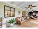 Covered patio with comfortable seating, ceiling fans, and stylish decor for outdoor living at 445 Songbird Way, Apopka, FL 32712