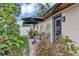 Landscaped side yard features a black patio umbrella and a privacy fence at 445 Songbird Way, Apopka, FL 32712