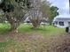 Expansive backyard featuring mature trees, offering shade and privacy at 5120 Lazy Lake Cir, Orlando, FL 32821