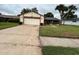 Inviting single-story home with a two-car garage, complemented by a well-kept lawn at 5120 Lazy Lake Cir, Orlando, FL 32821