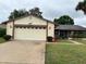 Charming single-story home with a two-car garage and well-maintained landscaping at 5120 Lazy Lake Cir, Orlando, FL 32821