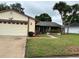 Lovely single-story home with a two-car garage, well-maintained lawn, and mature palm trees at 5120 Lazy Lake Cir, Orlando, FL 32821