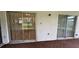 An empty patio with views into the kitchen that features dark cabinets and light countertops at 5120 Lazy Lake Cir, Orlando, FL 32821