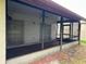 Screened in porch with seating area with view to lush backyard at 5120 Lazy Lake Cir, Orlando, FL 32821