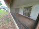A large empty screen porch with view to yard; perfect for Florida evenings at 5120 Lazy Lake Cir, Orlando, FL 32821