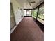 A spacious and empty screened in porch with tiled flooring and a ceiling fan at 5120 Lazy Lake Cir, Orlando, FL 32821