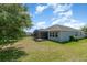 A well-maintained backyard with lush green grass and a screened patio at 5871 Alenlon Way, Mount Dora, FL 32757
