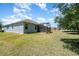 A well-maintained backyard with lush green grass and a screened patio at 5871 Alenlon Way, Mount Dora, FL 32757