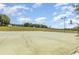 Outdoor basketball court with multiple hoops and lighting for evening play at 5871 Alenlon Way, Mount Dora, FL 32757