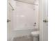Bathroom features a toilet and a shower with white tiles and modern fixtures at 5871 Alenlon Way, Mount Dora, FL 32757