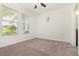 Bright bedroom with two large windows and neutral carpet at 5871 Alenlon Way, Mount Dora, FL 32757