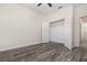 Cozy bedroom with wood-look floors and an open closet at 5871 Alenlon Way, Mount Dora, FL 32757