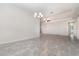 Bright dining room features tile floors, a modern chandelier, and a view into the adjacent living room at 5871 Alenlon Way, Mount Dora, FL 32757
