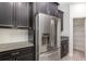 Stainless steel refrigerator and dark cabinetry enhance this modern kitchen at 5871 Alenlon Way, Mount Dora, FL 32757