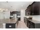 Spacious kitchen features stainless steel appliances, granite countertops, and stylish dark cabinetry at 5871 Alenlon Way, Mount Dora, FL 32757
