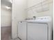 Laundry room features white washer and dryer and wire shelving at 5871 Alenlon Way, Mount Dora, FL 32757