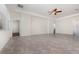 Spacious living room boasts tile floors, neutral paint, large windows, and a stylish ceiling fan at 5871 Alenlon Way, Mount Dora, FL 32757